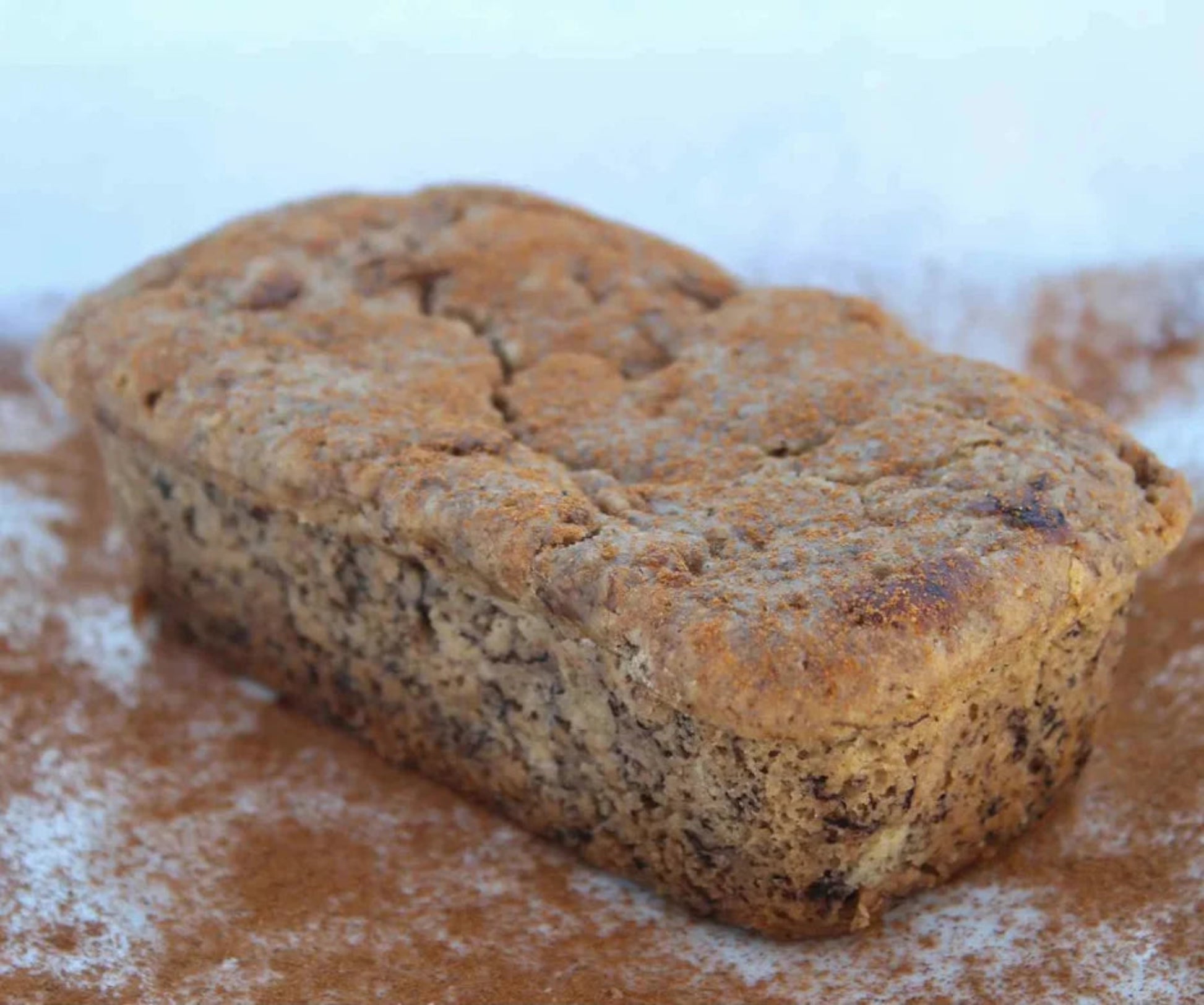 Loaf of bread on a wooden surface with a white background