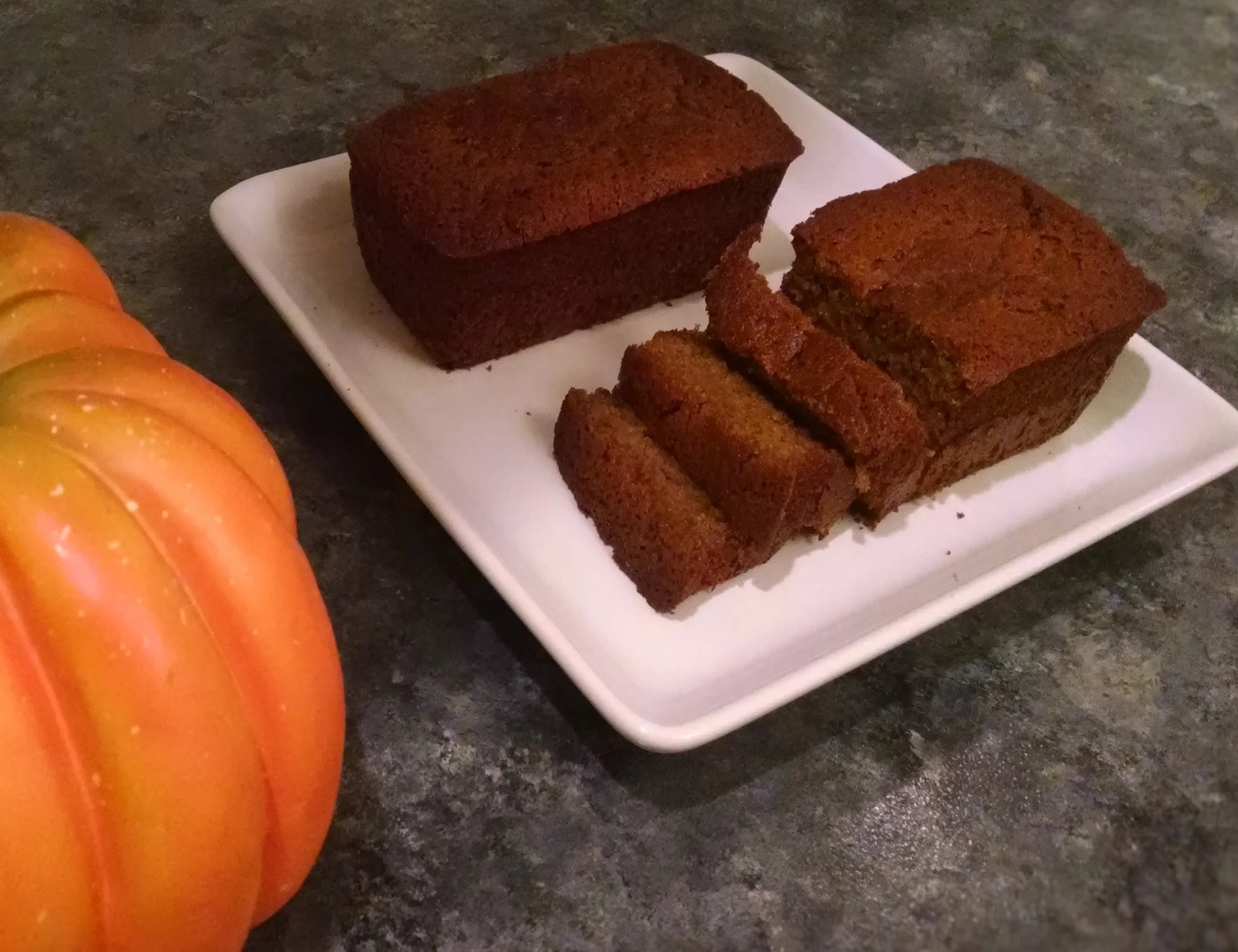 Two mini loaves of Pumpkin Bread on a white plate.