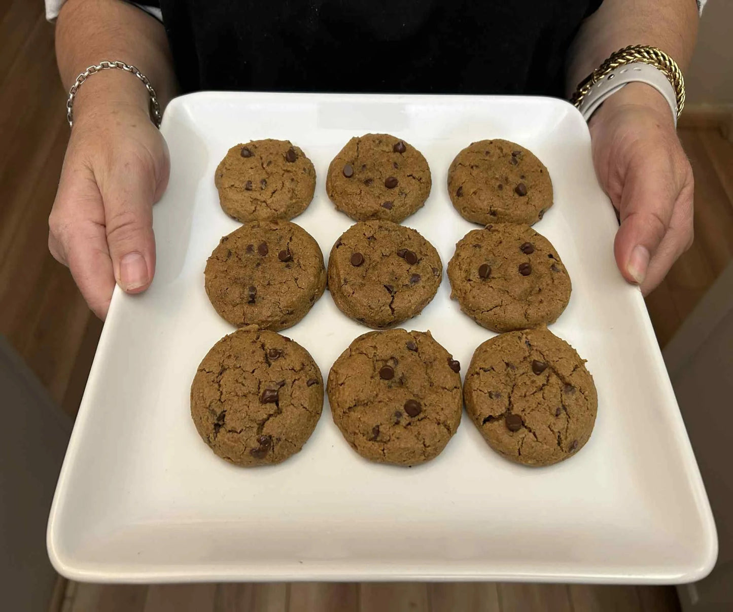 A white plate with some pumpkin chocolate chip cookies.