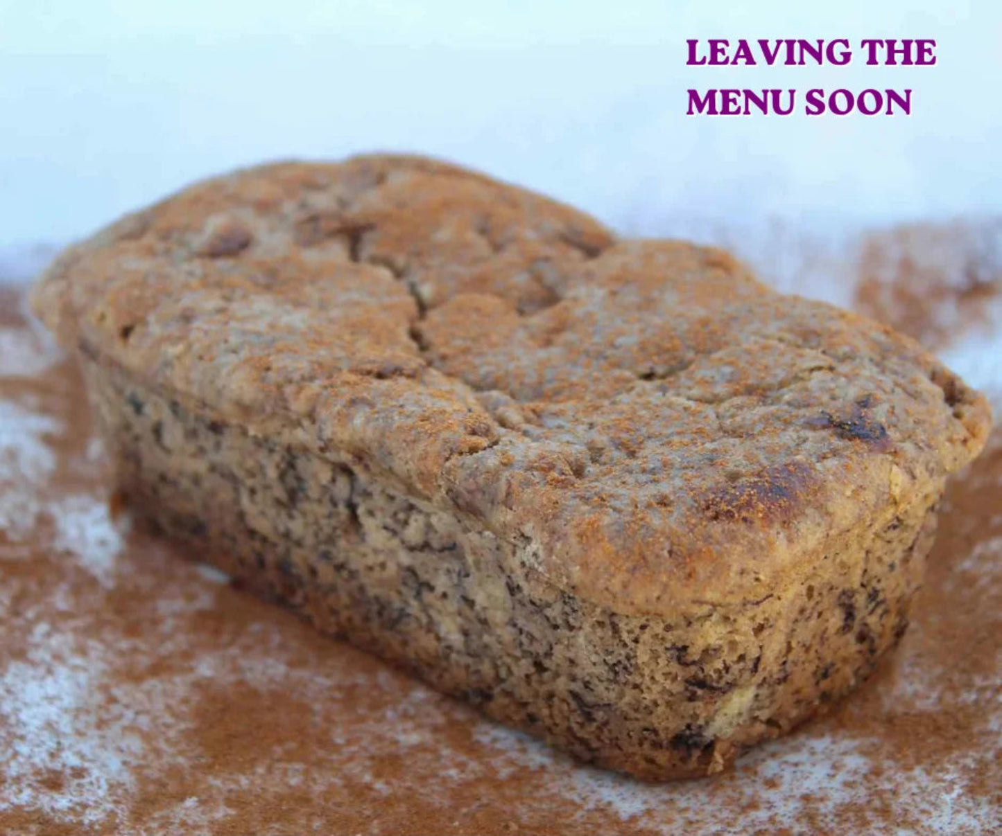 Loaf of bread on a surface with text 'LEAVING THE MENU SOON' displayed.
